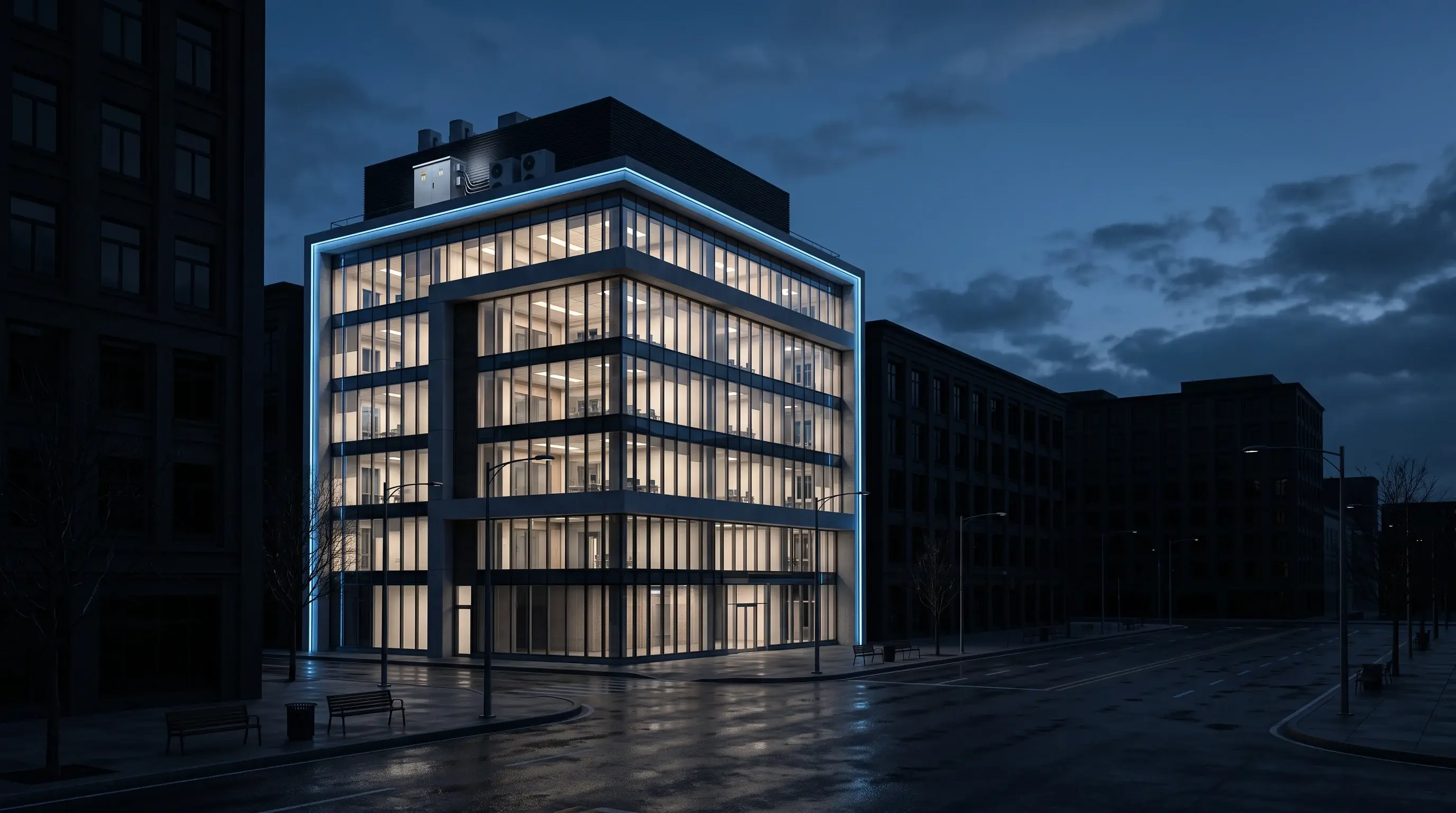 A lit office building at night on a street where every neighbouring building is dark